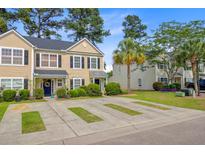 Charming two-story townhouse with a well-manicured lawn and a patterned concrete driveway at 9010 Maple Grove Dr, Summerville, SC 29485