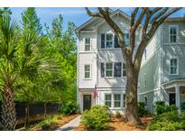 Charming home with traditional siding, mature trees, and manicured landscaping, creating inviting curb appeal at 977 Warrick Oaks Ln, Mount Pleasant, SC 29464