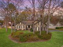 Charming single-story home featuring a well-maintained lawn and a mix of mature trees at 101 Plantation Dr, Summerville, SC 29485