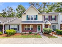 Inviting two-story townhouse with colorful shutters, brick accents and manicured landscaping at 1201 Pine Bluff Dr, Summerville, SC 29483