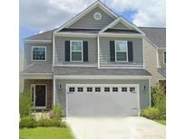 Charming two-story home featuring gray siding, black shutters, and a two-car garage at 127 Longford Dr, Summerville, SC 29483