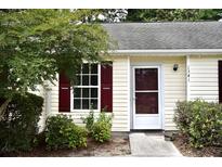 Charming home featuring red shutters and a well-maintained front yard with lush greenery at 1341 Pinnacle Ln, Charleston, SC 29412