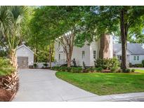 Charming two-story home with lush landscaping, a detached garage, and a winding driveway at 1514 Village Sq, Mount Pleasant, SC 29464