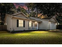 Charming single-story home with cozy porch and well-maintained lawn under a colorful evening sky at 210 Basswood Ave, Summerville, SC 29483