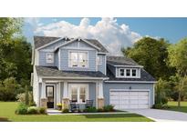 Charming two-story home featuring light blue siding, a welcoming front porch, and an attached two-car garage at 214 Callibluff Dr, Summerville, SC 29486