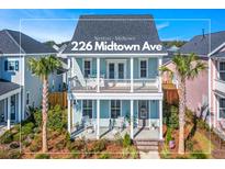 Charming two-story coastal home with dual porches, lush landscaping and inviting curb appeal in Nexton Midtown at 226 Midtown Ave, Summerville, SC 29486