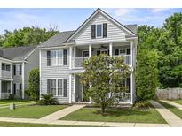 Charming two-story home featuring double porches, gray siding, black shutters, and a well-manicured lawn at 243 Old Savannah Dr, Goose Creek, SC 29445