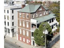 Beautiful brick home featuring a green roof, symmetrical windows, and a charming balcony at 286 Meeting St # C, Charleston, SC 29407