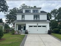 Charming, modern farmhouse with a two-car garage and professionally landscaped yard at 31 Wedgepark Rd, Charleston, SC 29407
