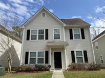 Charming two-story home with landscaped yard and classic architectural details at 4936 Ballantine Dr, Summerville, SC 29485
