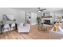 Bright living room with hardwood floors, a fireplace, and comfortable seating for entertaining at 4965 Foxwood Dr, North Charleston, SC 29418