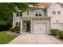 Charming two-story home with a light green exterior, white trim, and a single-car garage in a well-maintained neighborhood at 5001 Hay Bale Ct, Summerville, SC 29485