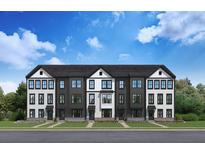 Charming new construction townhomes featuring a black and white exterior and manicured lawns at 562 Scholar Way, Summerville, SC 29486