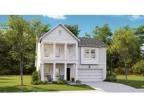 Charming two-story home featuring a welcoming front porch and a two car garage at 1034 Scotch Bonnet Way, Summerville, SC 29485