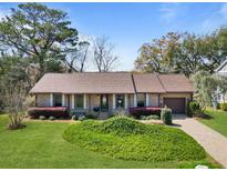 Charming brick home with well-manicured lawn and flowering shrubs enhancing its curb appeal at 1039 Grand Concourse St, Charleston, SC 29412