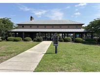 Community clubhouse features a covered area, green space, and manicured landscaping at 107 Brookhaven Rd, Summerville, SC 29486