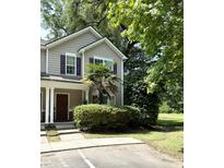 Charming townhome featuring a well-maintained lawn, purple shutters, and a welcoming front entrance at 107 Twin Tree Dr, Summerville, SC 29485
