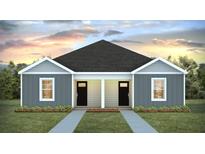 Charming duplex featuring a gray exterior, black doors, and well-manicured landscaping at 123 Mims Academy Dr, Harleyville, SC 29448