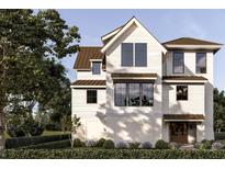 Charming two-story home with a gabled roof, light siding, large windows and meticulously landscaped front yard at 13 Trumbo St, Charleston, SC 29401