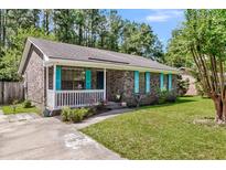 Charming single-story brick home featuring a covered porch, vibrant shutters, and a well-manicured front yard at 202 Pamela Ln, Summerville, SC 29483