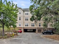 Exterior view of the building with drive-through and mature trees in a well-maintained setting at 2244 Ashley Crossing Dr # 534, Charleston, SC 29414