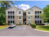 Well-maintained condo building with a tan exterior and spacious screened balconies at 2632 Egret Crest Ln, Charleston, SC 29414