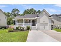 Charming single-Gathering home with a well-manicured lawn and inviting front porch at 3061 Penny Ln, Johns Island, SC 29455