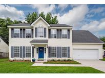 Charming two-story home featuring blue shutters, a well-manicured lawn, and an attached two-car garage at 3092 Morningdale Dr, Mount Pleasant, SC 29466