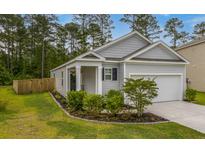 Charming single-story home with well-manicured landscaping and an attached one car garage at 444 Cedarview Rd, Summerville, SC 29486