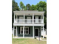 Charming two-story home with a classic design, complemented by a well-maintained lawn and surrounded by lush greenery at 4818 Buttercup Way, Summerville, SC 29485