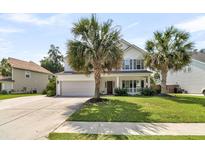Charming two-story home with a manicured lawn and mature palm trees enhancing its curb appeal at 5257 Mulholland Dr, Summerville, SC 29485