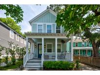 Charming two-story home featuring a welcoming front porch, manicured landscaping, and a light blue exterior at 1076 Hatfield St, North Charleston, SC 29405