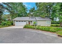 Charming single-story home with a metal roof, attached garage, and landscaped front yard at 109 Willow Ct, Summerville, SC 29486