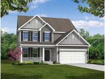 Charming two-story home featuring a covered porch, attached two-car garage, and beautifully landscaped front yard at 114 Shingle Oak Dr, Moncks Corner, SC 29461