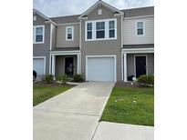 Charming two-story townhouse with a one car garage, well-maintained lawn, and neutral-toned exterior at 116 Gaura Ln, Summerville, SC 29483
