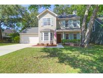 Charming two-story home featuring neutral siding, an attached garage, and well-manicured front yard at 1394 Center Lake Dr, Mount Pleasant, SC 29464