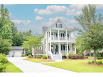 Charming two-story home with double porches, manicured lawn, and inviting curb appeal at 1566 Lindsey Creek Dr, Mount Pleasant, SC 29466