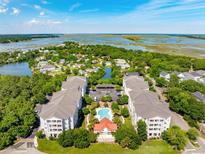 Beautiful aerial view of coastal condo community with pool and marsh views at 1984 Folly Rd # A310, Charleston, SC 29412