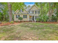 Charming two-story home with manicured lawn and lush trees in a desirable neighborhood at 2028 Prospect Hill Dr, Mount Pleasant, SC 29464