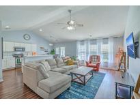 Inviting living room with plush sectional, ceiling fan, and natural light from large windows at 210 Delafield Dr, Summerville, SC 29483