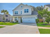 Charming two-story home with a well-maintained lawn, two-car garage, and a welcoming front entrance at 211 Saxony Loop, Summerville, SC 29486