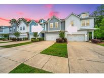 Charming row of townhomes featuring varied architectural styles and well-manicured landscaping at 2402 Brackish Dr, Mount Pleasant, SC 29466