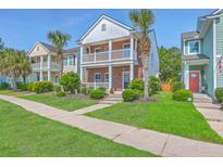 Charming two-story brick home boasts a double balcony, palm trees, and well-maintained landscaping at 2931 Waterleaf Rd, Johns Island, SC 29455