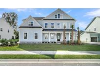 Charming two-story home featuring a covered front porch, manicured lawn and classic curb appeal at 4000 Saltwater Cir, Johns Island, SC 29455