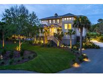 Stunning two-story home with a lush lawn, mature trees, and inviting curb appeal at 4121 Golf Cottage Ln, Johns Island, SC 29455