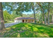 Charming single-story home featuring a spacious front yard and attached two car garage at 441 Compton Dr, Moncks Corner, SC 29461