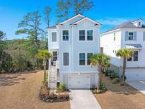 Charming two-story home with light blue siding, white trim, and a one-car garage at 840 Forrest Dr, Charleston, SC 29492