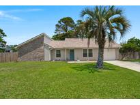 Charming single-story home with a well-manicured lawn and a welcoming turquoise front door at 106 Brown Ct, Summerville, SC 29486