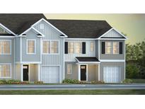 Charming townhome showcasing craftsman-style architecture, private garages, and beautifully landscaped surroundings at 137 Haventree Ct, Summerville, SC 29486