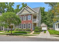 Charming two-story home featuring brick accents, a cozy porch, and a well-manicured lawn at 1408 Bimini Dr, Charleston, SC 29414